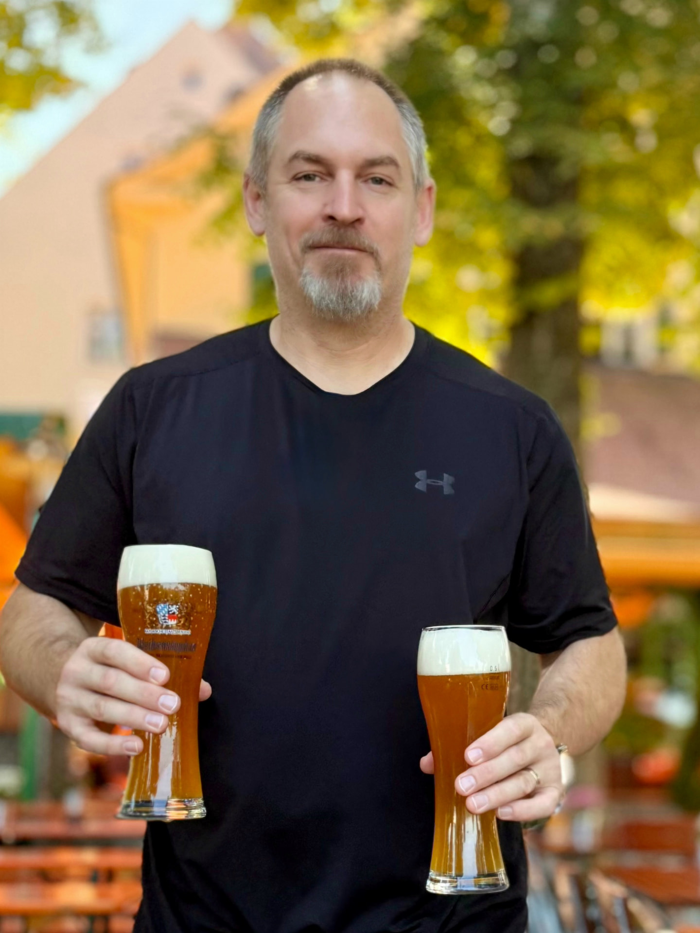 Rockne Van Meter, head brewmaster at Redwood Brewing Co., holding two freshly poured beers