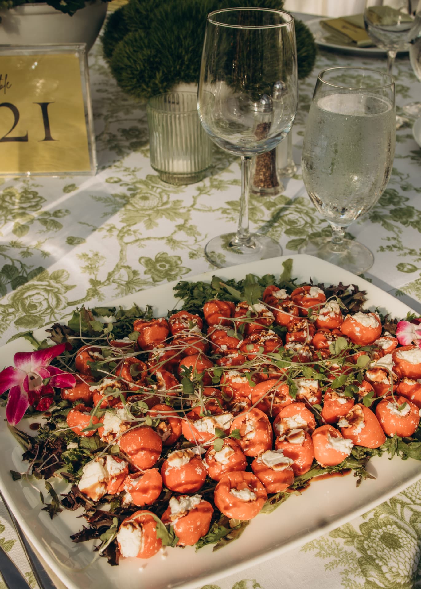 Platter of stuffed peppadew peppers with goat cheese and microgreens