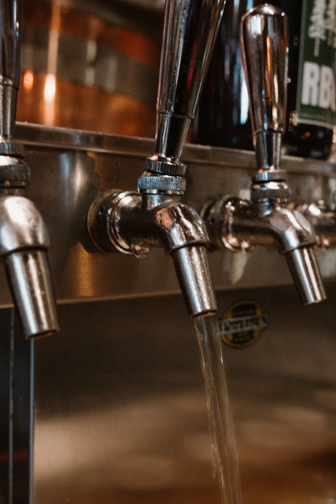 Beer pouring from a stainless tap at the Redwood brewhouse