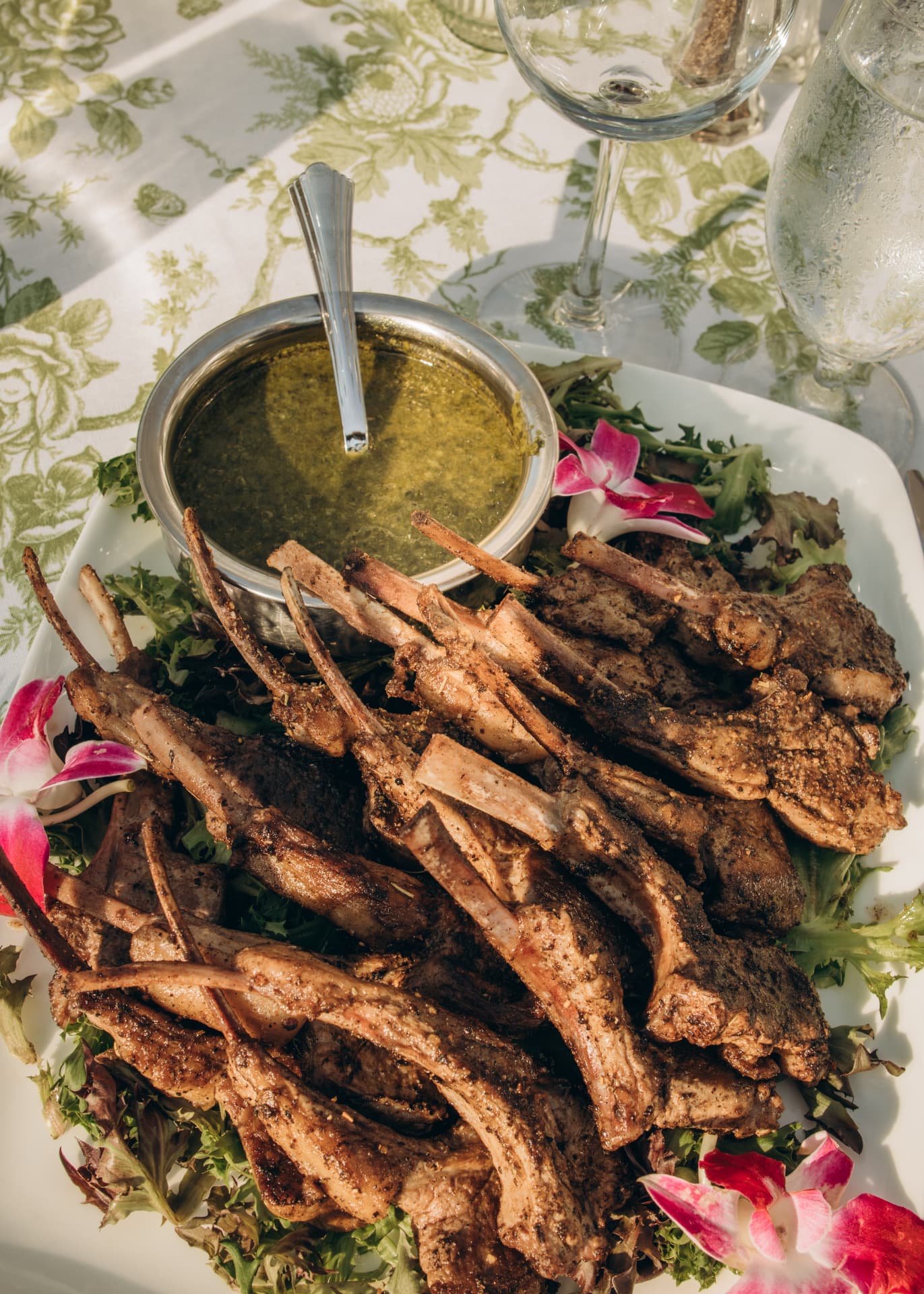 Grilled lamb chops with chimichurri on a bed of greens