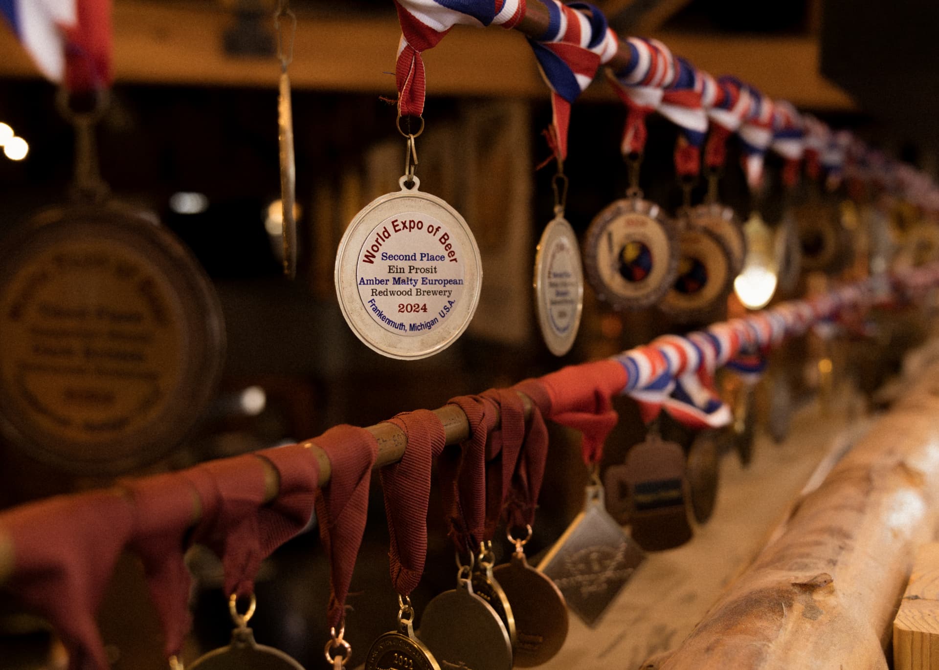 A rail of beer competition medals earned by Redwood Brewing Company