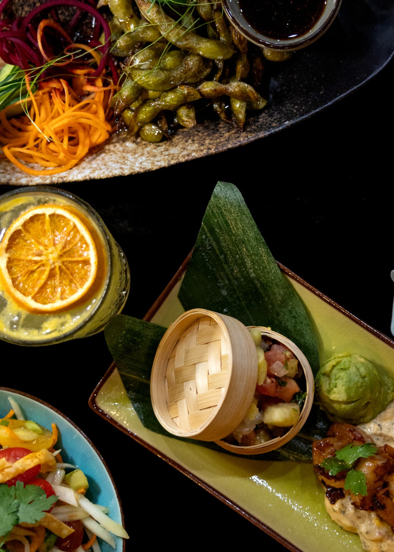 Blistered edamame and ceviche in a bamboo steamer