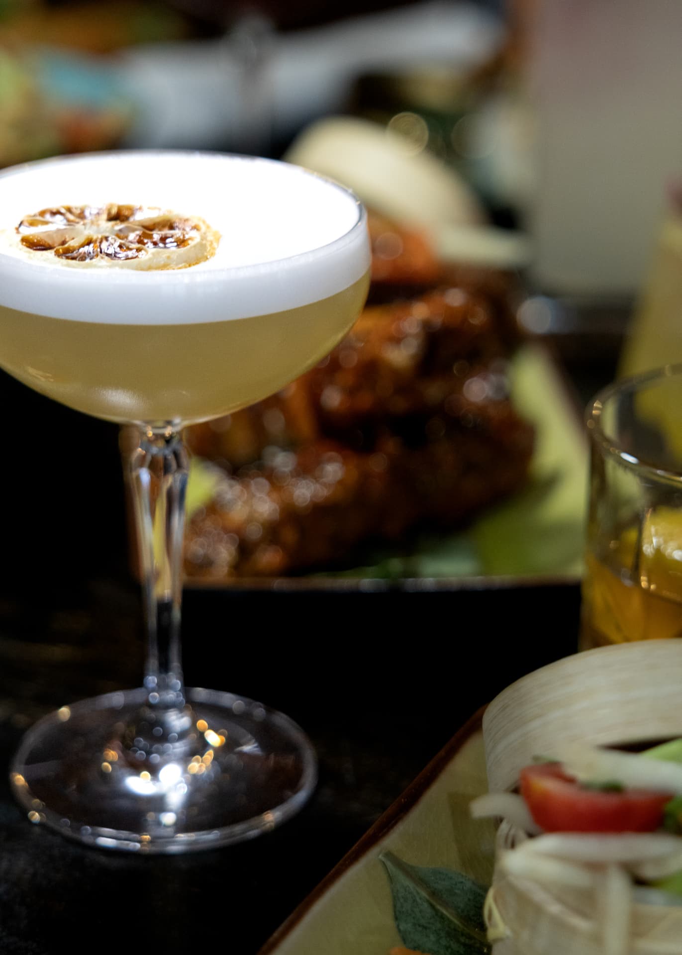 Coupe cocktail with a charred citrus wheel at Sequoia