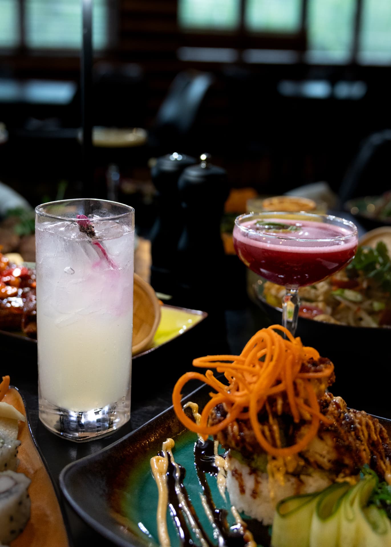 Two Sequoia cocktails with a sushi roll in the foreground